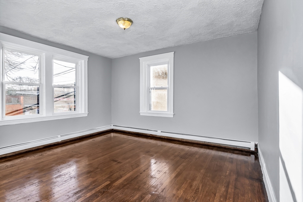 88 Congress Street, Unit 3 Salem, MA 01970 - Photo 14 of 31 an empty room with wooden floor and windows