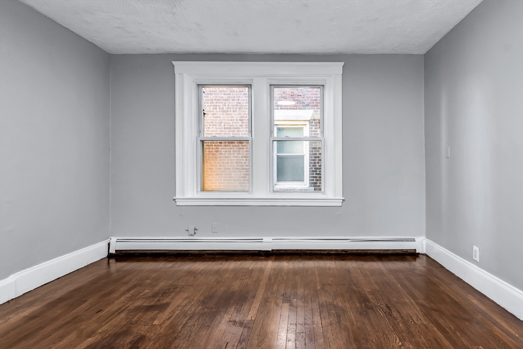 88 Congress Street, Unit 3 Salem, MA 01970 - Photo 15 of 31 wooden floor in an empty room with a window