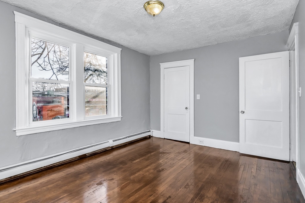 88 Congress Street, Unit 3 Salem, MA 01970 - Photo 19 of 31 wooden floor in an empty room with a window