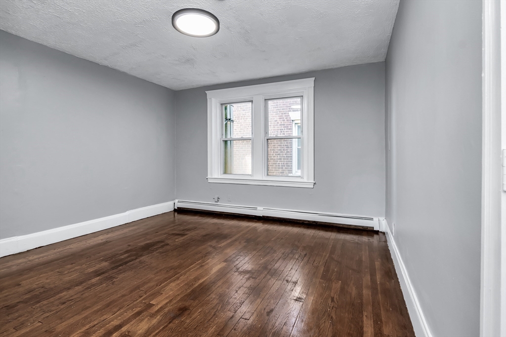 88 Congress Street, Unit 3 Salem, MA 01970 - Photo 2 of 31 an empty room with wooden floor and windows