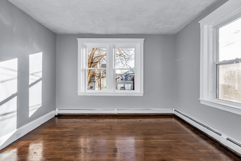 88 Congress Street, Unit 3 Salem, MA 01970 - Photo 21 of 31 a view of an empty room with wooden floor and a window