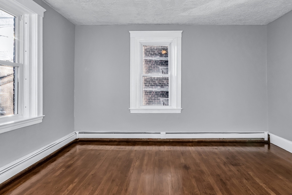 88 Congress Street, Unit 3 Salem, MA 01970 - Photo 22 of 31 an empty room with wooden floor and windows