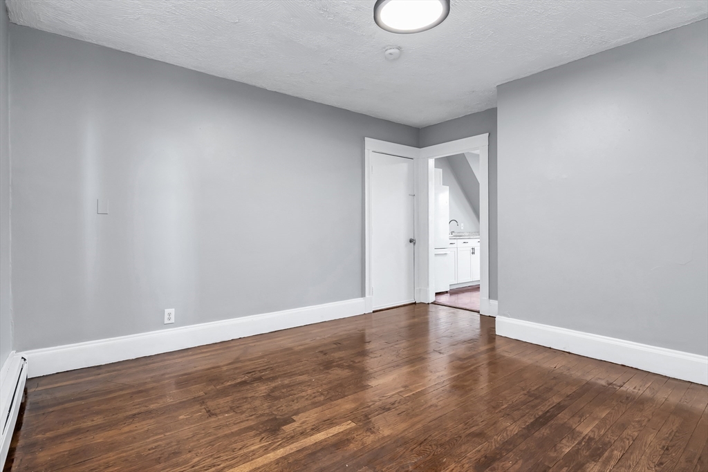 88 Congress Street, Unit 3 Salem, MA 01970 - Photo 4 of 31 a view of an empty room with wooden floor