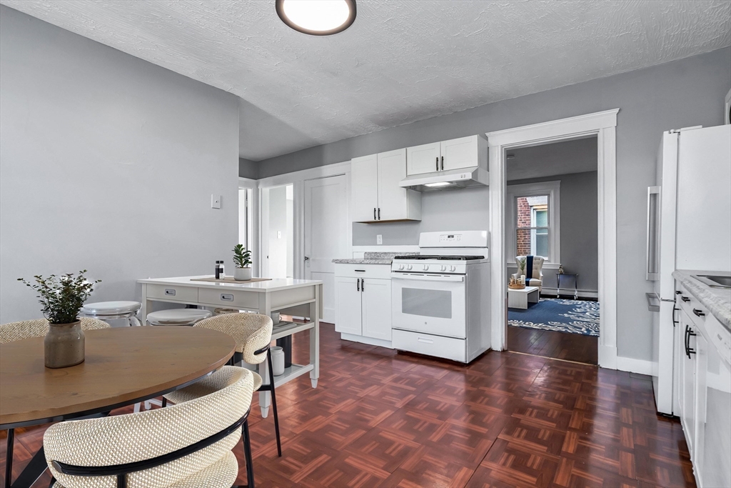 88 Congress Street, Unit 3 Salem, MA 01970 - Photo 5 of 31 a kitchen with white cabinets and appliances