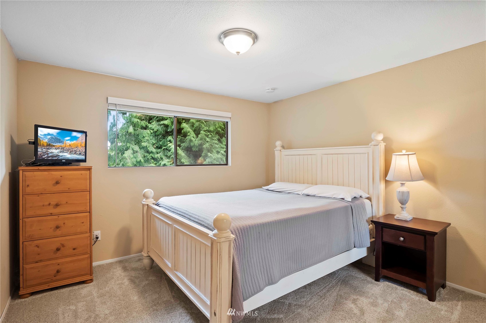 22224 3rd Avenue Southeast Bothell, WA 98021 - Photo 16 of 30 a bedroom with a bed and a tv on dresser
