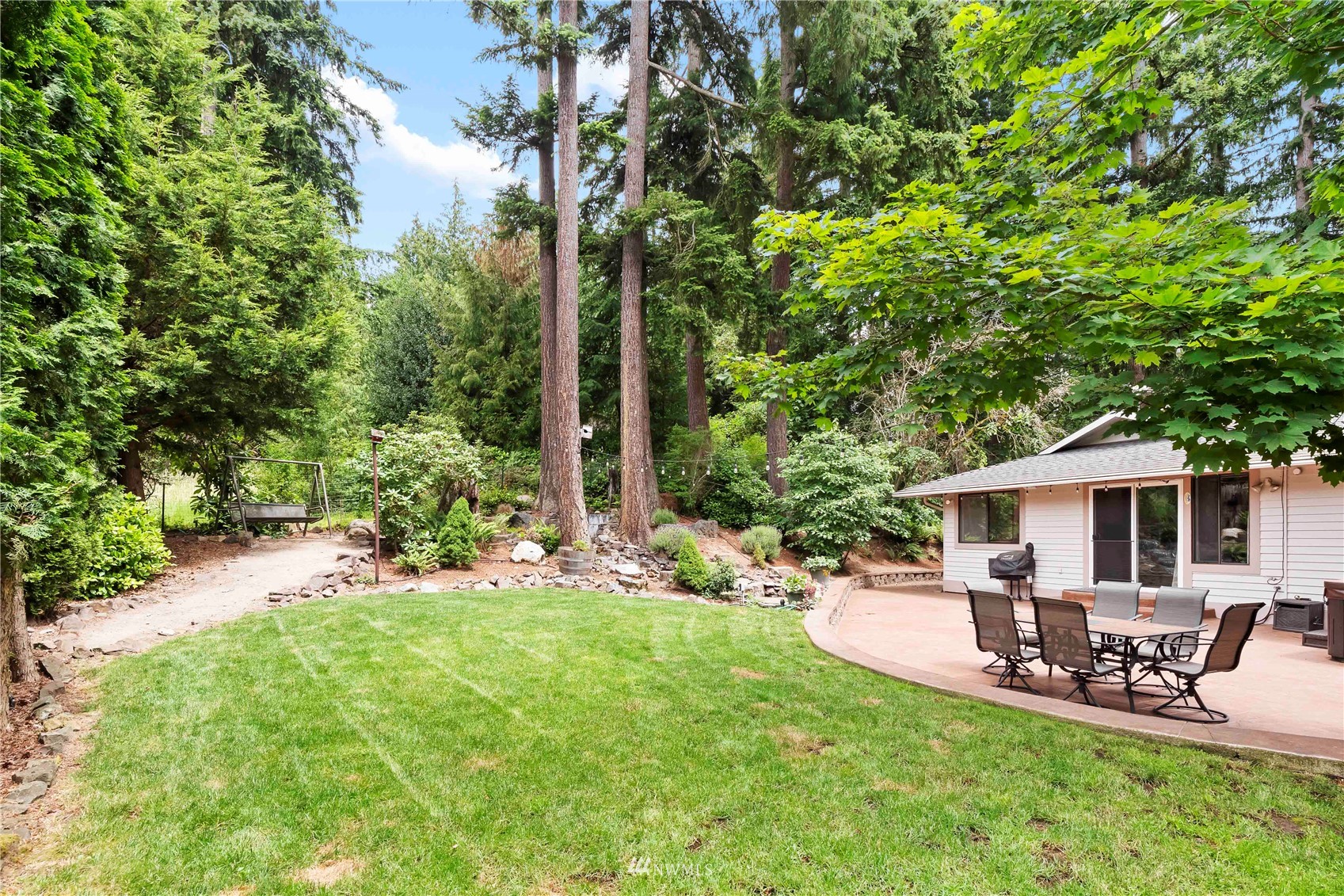 22224 3rd Avenue Southeast Bothell, WA 98021 - Photo 25 of 30 a view of a patio with table and chairs under an umbrella