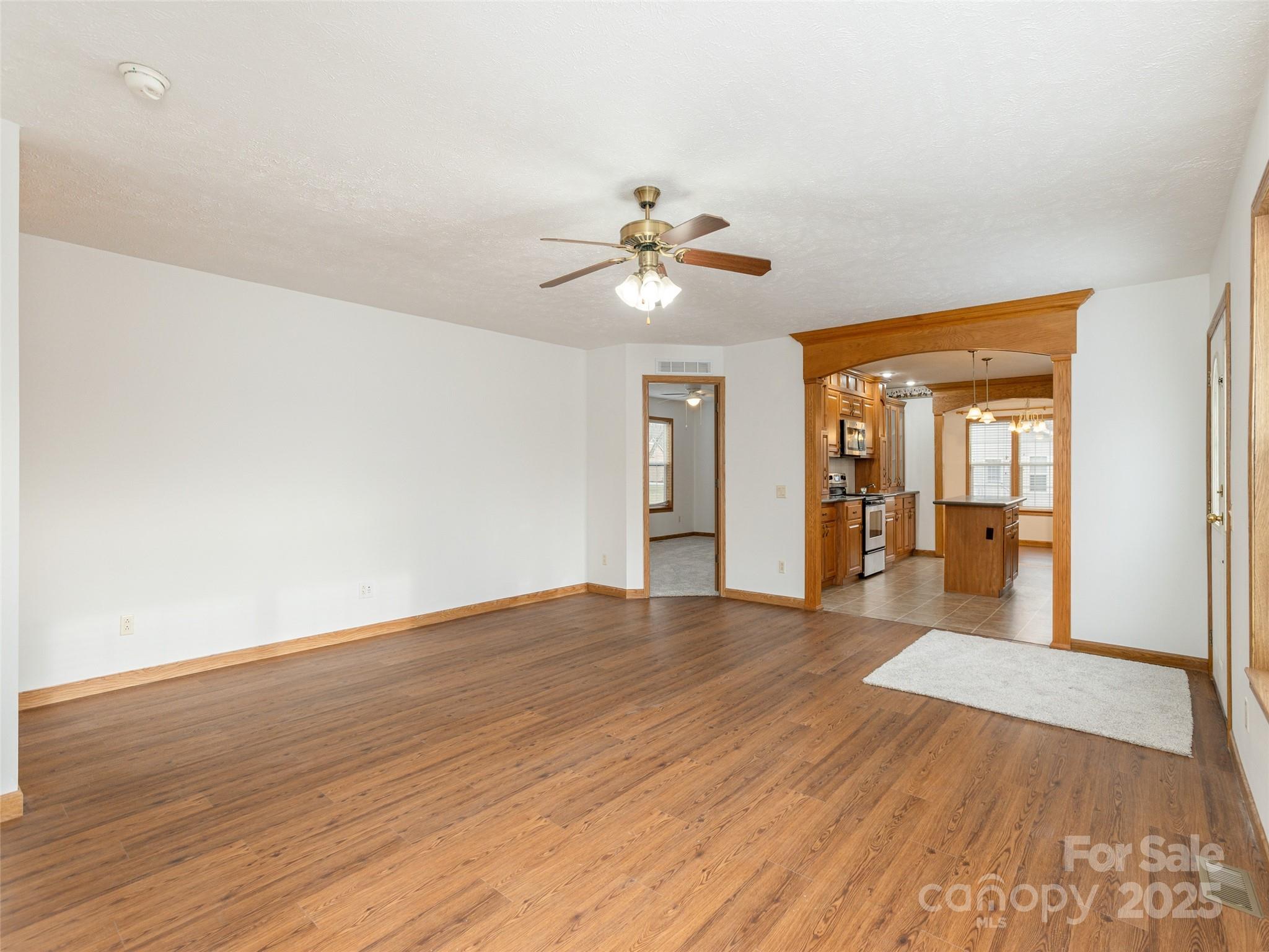 65 Philips Court Fletcher, NC 28732 - Photo 5 of 18 a view of a room with wooden floor and a ceiling fan