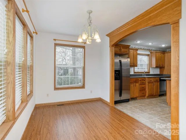a view of a kitchen with a sink and refrigerator