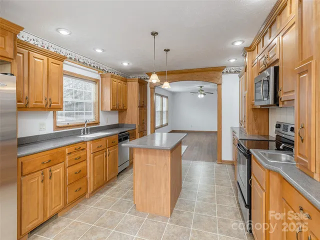 a kitchen with stainless steel appliances granite countertop a sink and a stove
