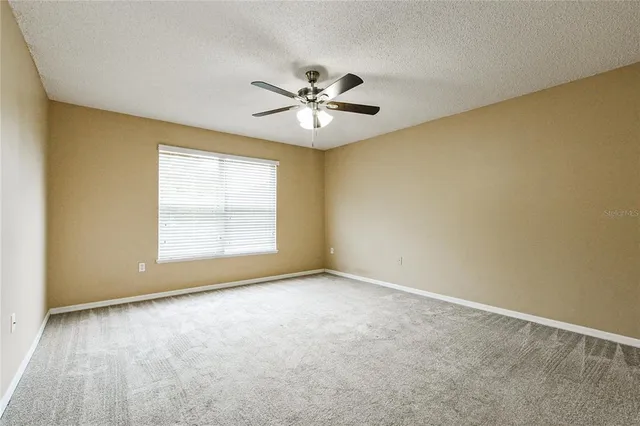 a view of room with a ceiling fan and window