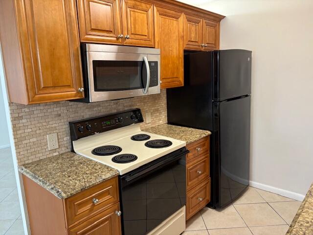 2035 Exeter, Unit 2035 Boca Raton, FL 33434 - Photo 1 of 15 a kitchen with stainless steel appliances granite countertop a stove microwave and refrigerator