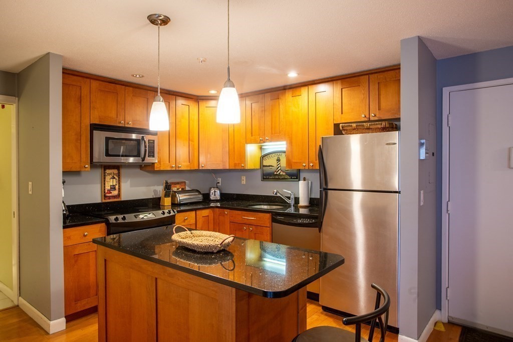 11 Church Street, Unit 101 Salem, MA 01970 - Photo 12 of 31 a kitchen with a refrigerator a stove a sink and a refrigerator