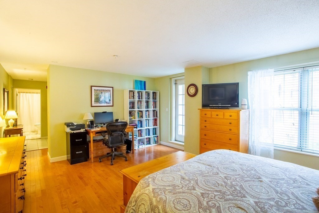 11 Church Street, Unit 101 Salem, MA 01970 - Photo 18 of 31 a bedroom with a bed and wooden floor