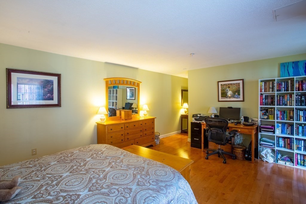 11 Church Street, Unit 101 Salem, MA 01970 - Photo 20 of 31 a bedroom with a workspace and a bookshelf
