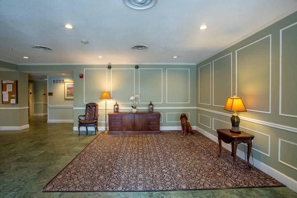 11 Church Street, Unit 101 Salem, MA 01970 - Photo 30 of 31 a living room with furniture a rug and a table