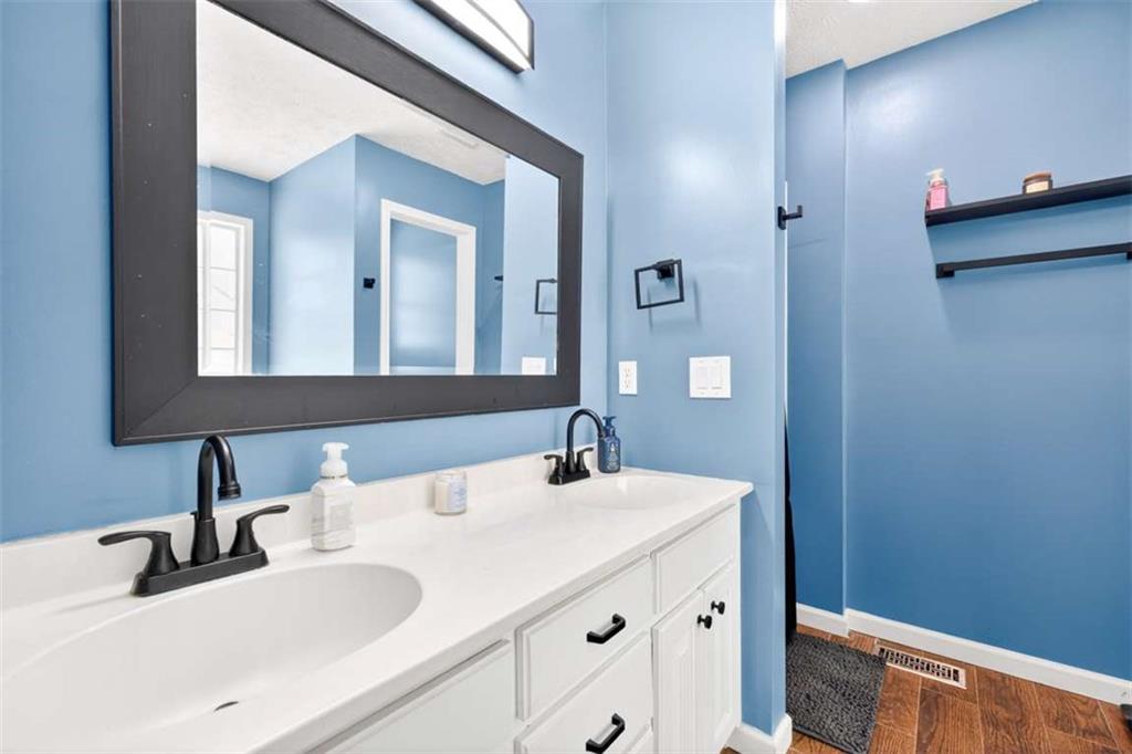 386 Ridgewood Drive Pendergrass, GA 30567 - Photo 26 of 50 a bathroom with a sink and a mirror