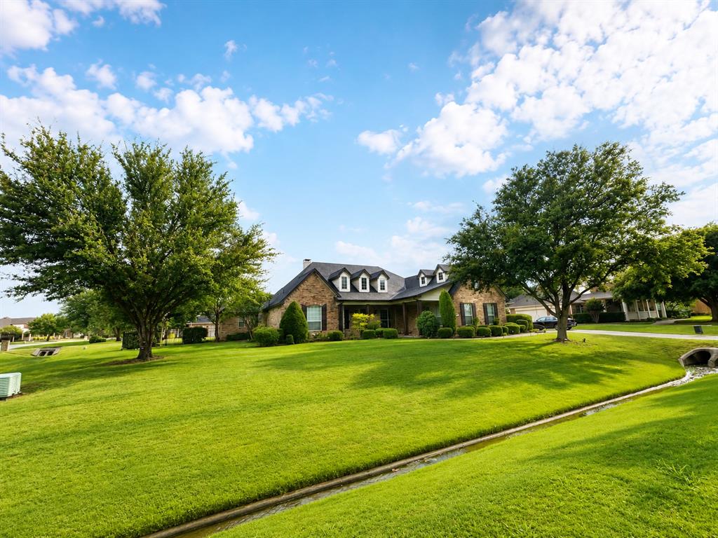6004 Ridgemore Drive Parker, TX 75002 - Photo 12 of 13 a view of an house with a big yard and garden