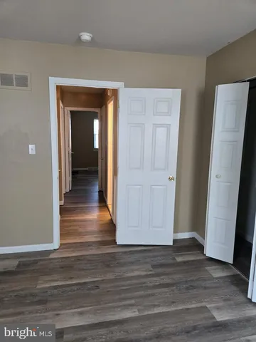 a view of hallway with wooden floor