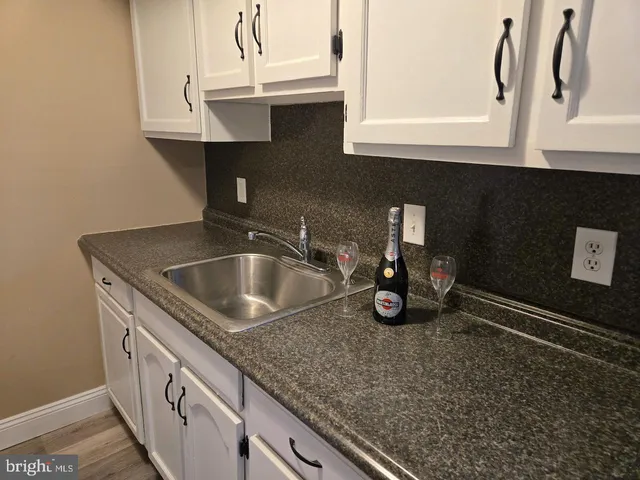 a kitchen with a sink and cabinets