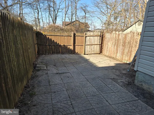 a view of a yard with wooden fence