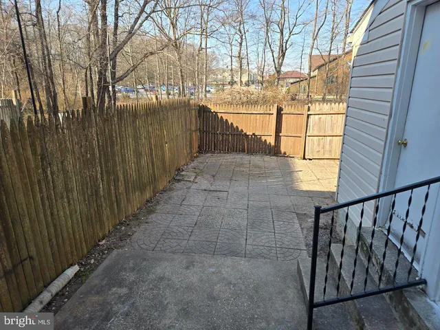 a view of a pathway with a wrought fence