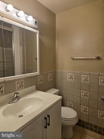 a bathroom with a sink toilet and mirror