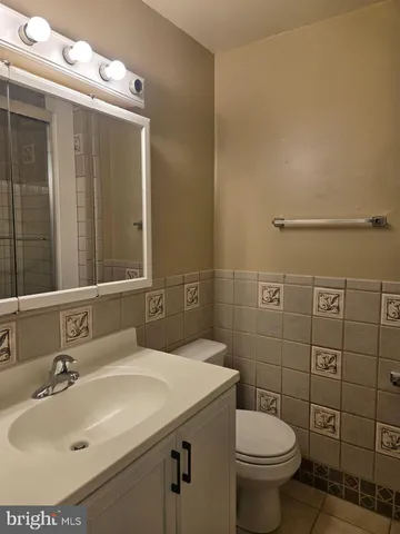 a bathroom with a sink toilet and mirror