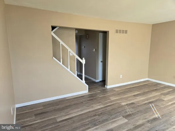 a view of an entryway with wooden floor