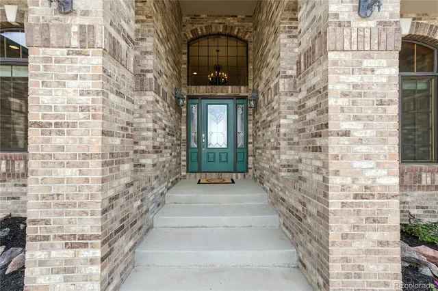 a large kitchen with stainless steel appliances granite countertop a stove top oven a sink a dining table and chairs