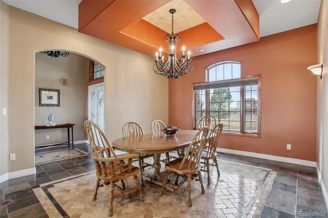 a room with pool table and windows