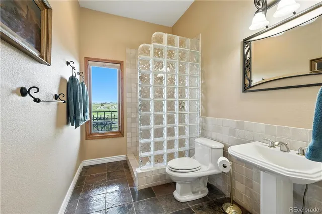 a spacious bedroom with a bed and a potted plant