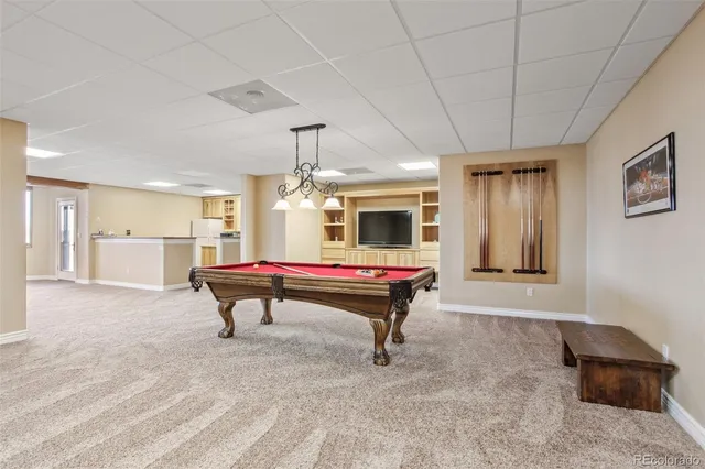 a view of a patio with couple of chairs and a fireplace