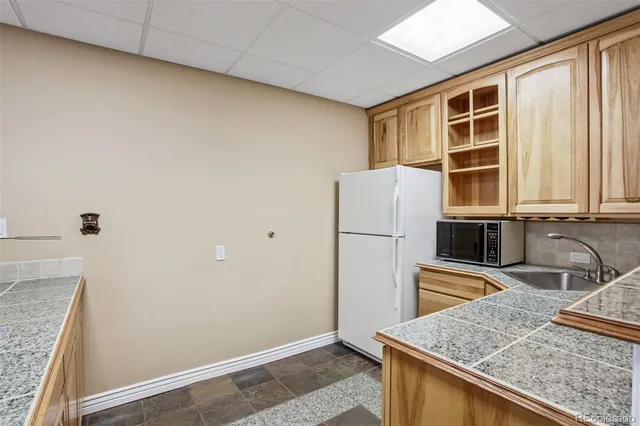 an aerial view of a house with a garden and lake view