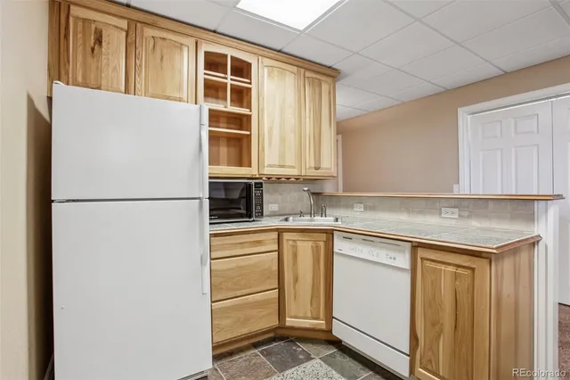 a front view of a house with a garden and yard