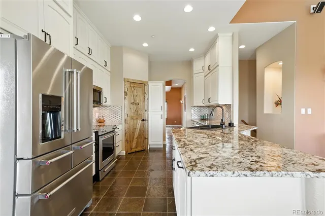 a bed sitting in a spacious bedroom next to a window
