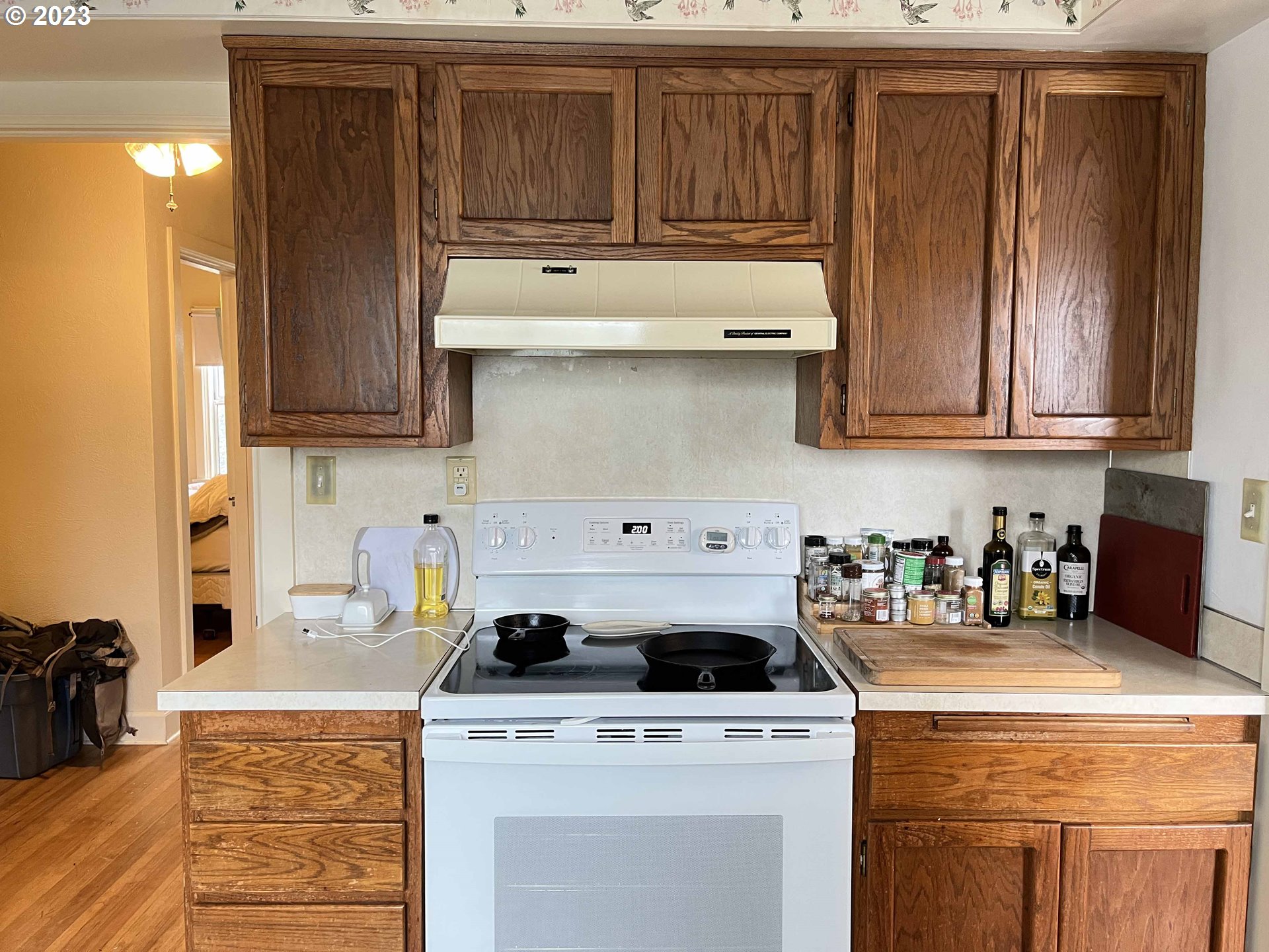 611 Laurel Street Florence, OR 97439 - Photo 19 of 32 a kitchen with granite countertop wood cabinets and white appliances