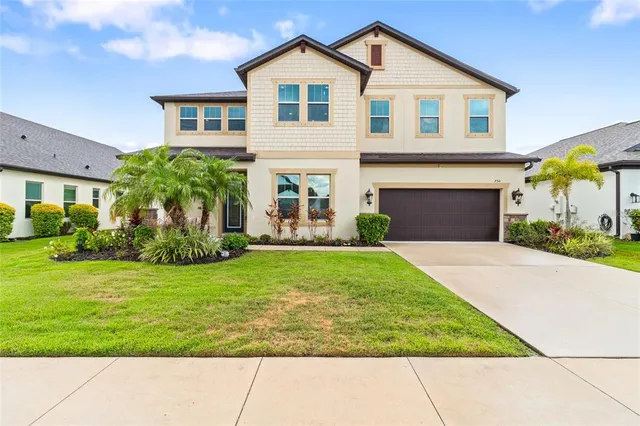 a front view of a house with a garden and plants