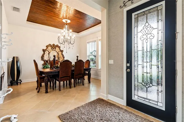 a view of a dining room with furniture and chandelier