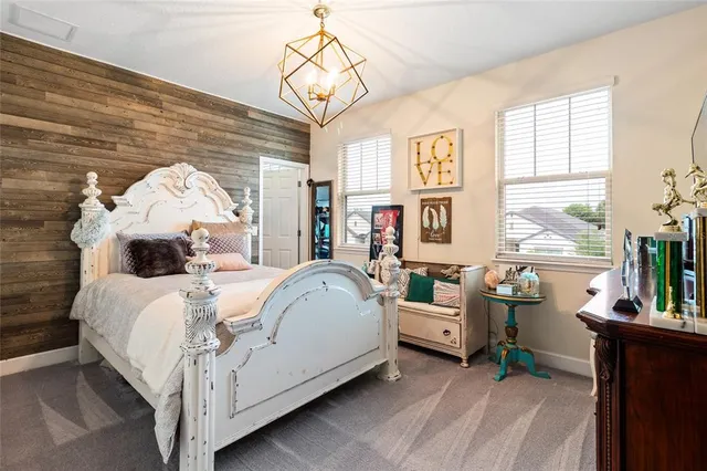 a bed room with a bed and a chandelier