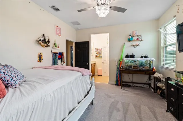 a bed room with a bed and a chandelier