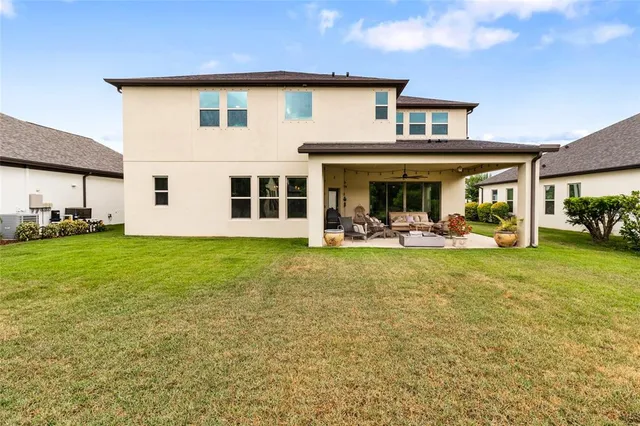 a view of a house with a backyard porch and sitting area