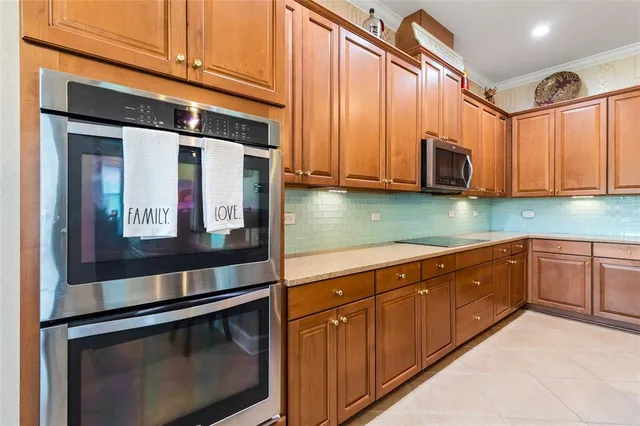 a kitchen with stainless steel appliances granite countertop a sink and a microwave