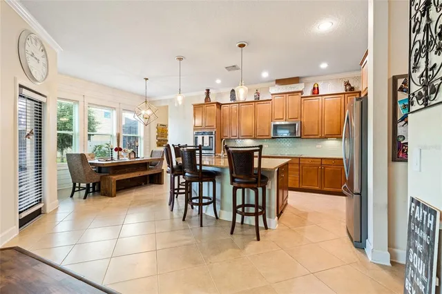 a dining hall view with a dining table chairs and large window