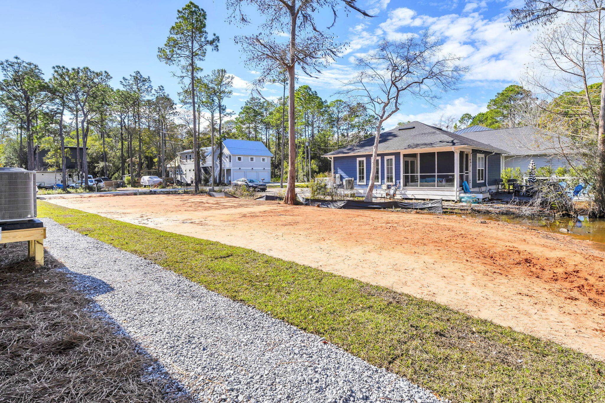 Lot 28 East Georgie Street Santa Rosa Beach, FL 32459 - Photo 2 of 6 a front view of a house with a yard and lake view