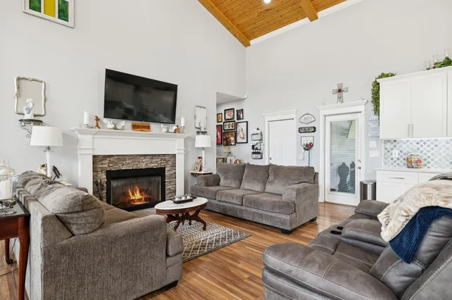 a living room with furniture fireplace and flat screen tv
