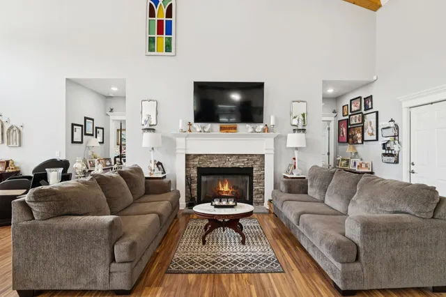 a living room with furniture flat screen tv and a fireplace