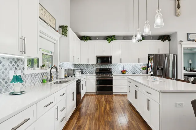 a kitchen with white cabinets and white appliances