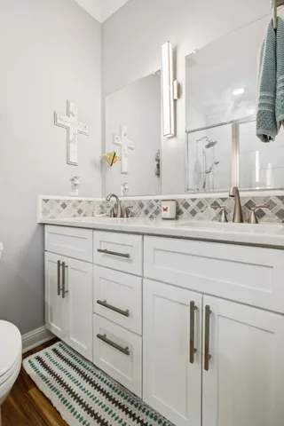 a bathroom with a sink toilet and mirror