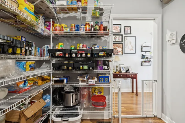 a room with stainless steel appliances and a table