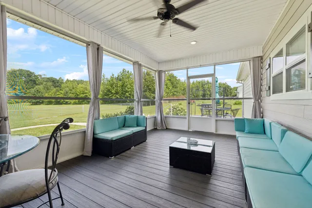 a living room with couch and a floor to ceiling window